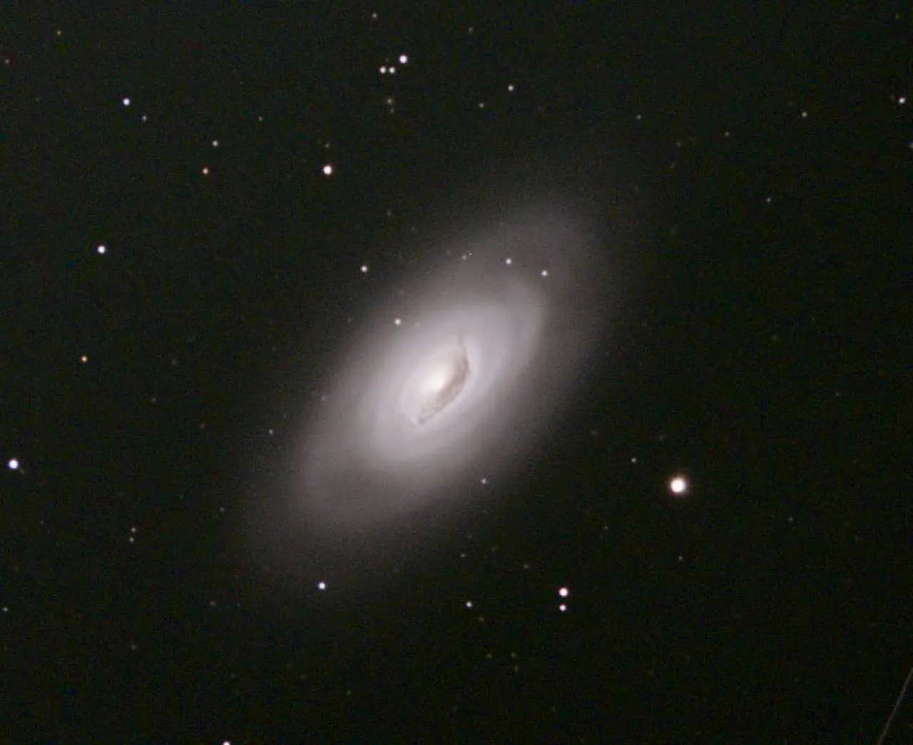 The Black Eye Galaxy, Messier 64, with a dark dust band across its bright core